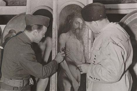 Le lieutenant Daniel J. Kern et Karl Sieber examinant un panneau de <em>L'Adoration de l'Agneau mystique</em>, 1945
